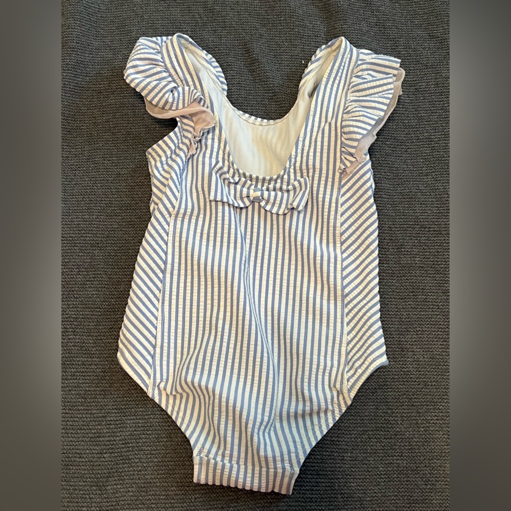 Rufflebutts blue and white stripes one piece swimsuit with little pink ruffles.